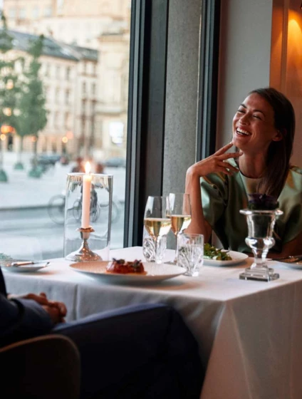 couple smiling at table at marchal -1600px