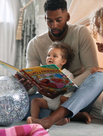 dad reading to girls by tent -1600px