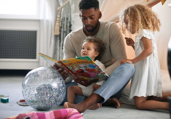 dad reading to girls by tent -1600px