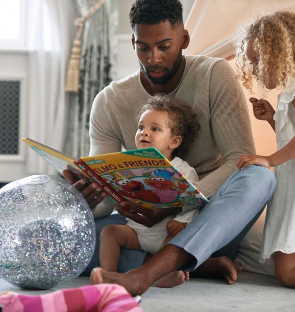 dad reading to girls by tent -1600px