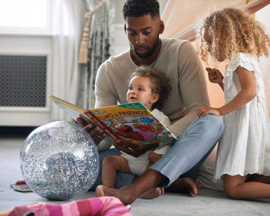 dad reading to girls by tent -1600px